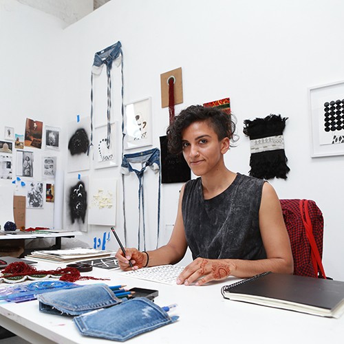 Sa'dia Rehman sitting in their office