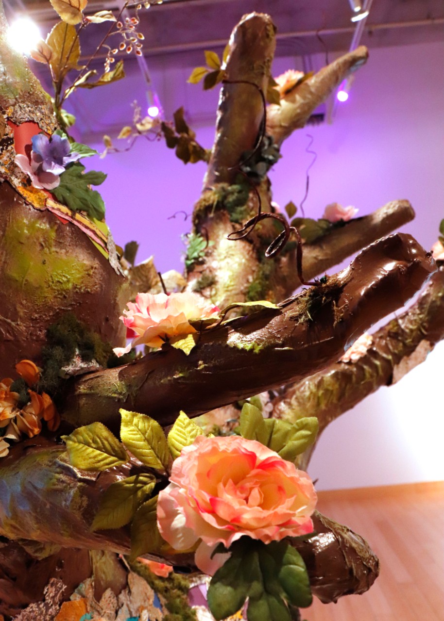 Houseplant by Nicole Moore, Jennah Hughes, Abbie Werner, Hannah Bundschuh, Recycled materials, paint cans, caulk, primer, paint swatches, fake flowers, fake moss, hot glue, metal, 2021