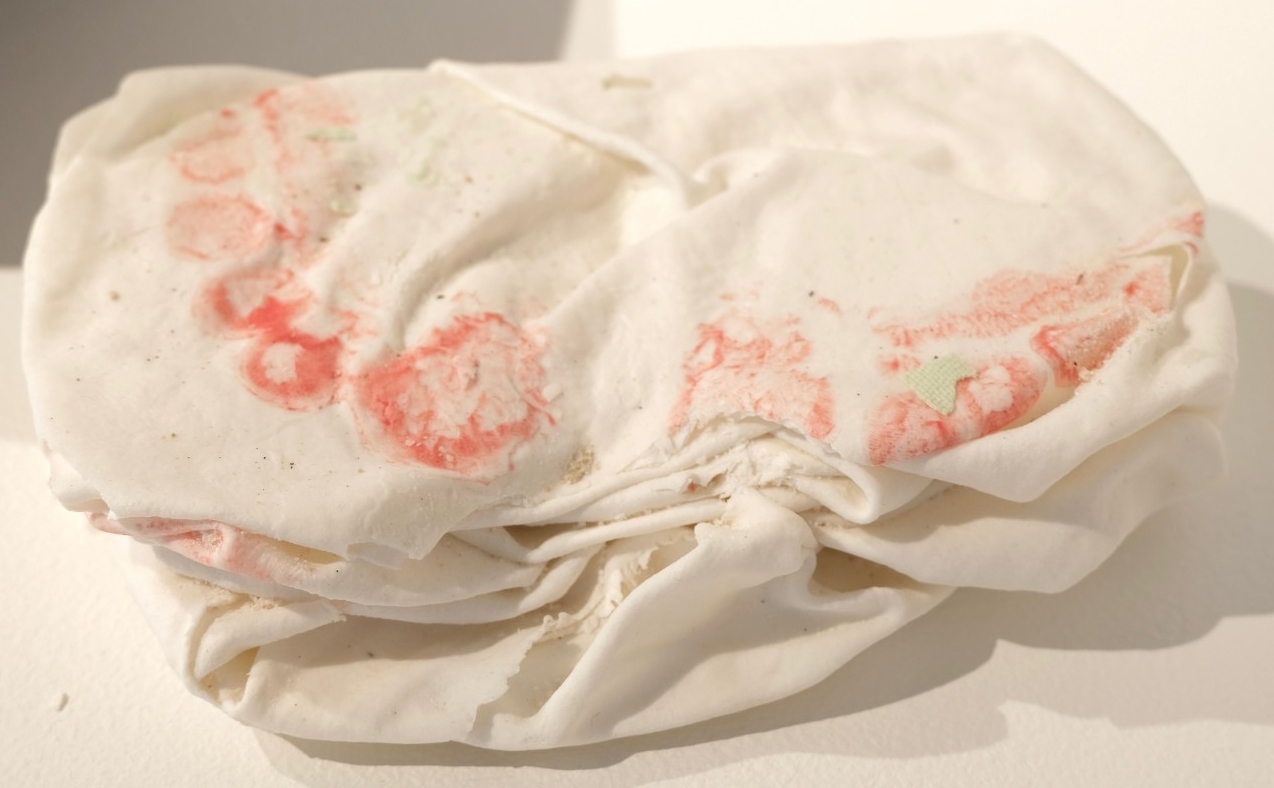 Dark stoneware clay, fired ceramics shards, fabric