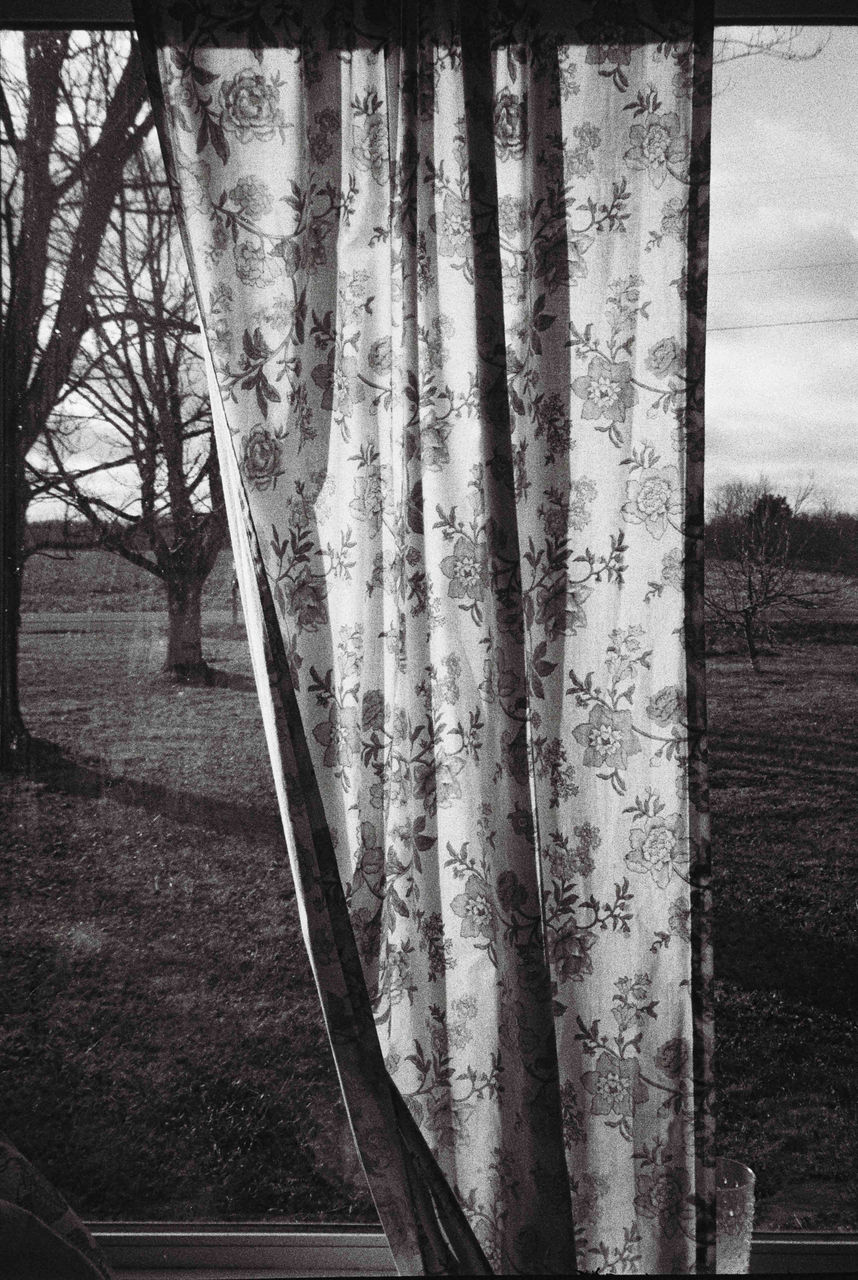 Black-and-white photograph of floral pattern sheet hanging outside titled Digression 39 by Mark Albain, 2020-2023; photo in Reed Gallery exhibit Long Exposure