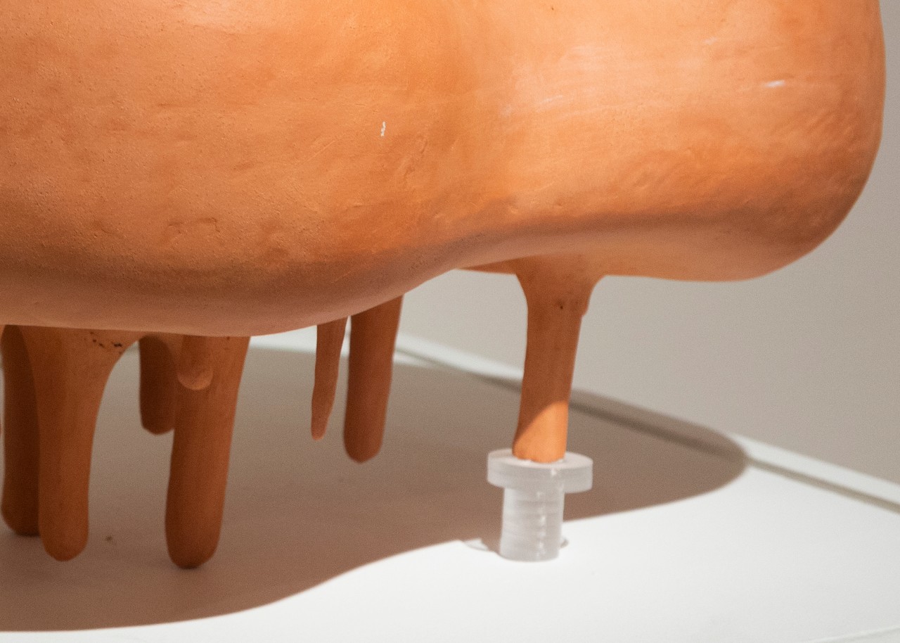 flesh-tone porcelain, terra cotta, and plexiglass cushion