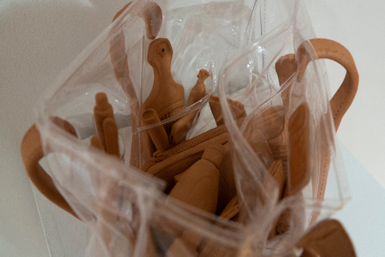 clear plastic tote bag filled with ceramic pieces